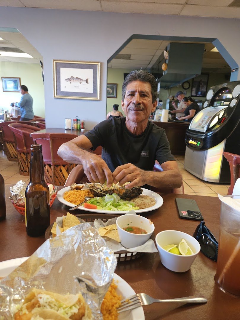Ceviche, shrimp cocktail, and fish tacos on display.